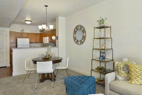 A kitchen with a dining table and chairs.