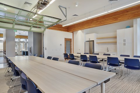 A conference room with a long table and chairs.