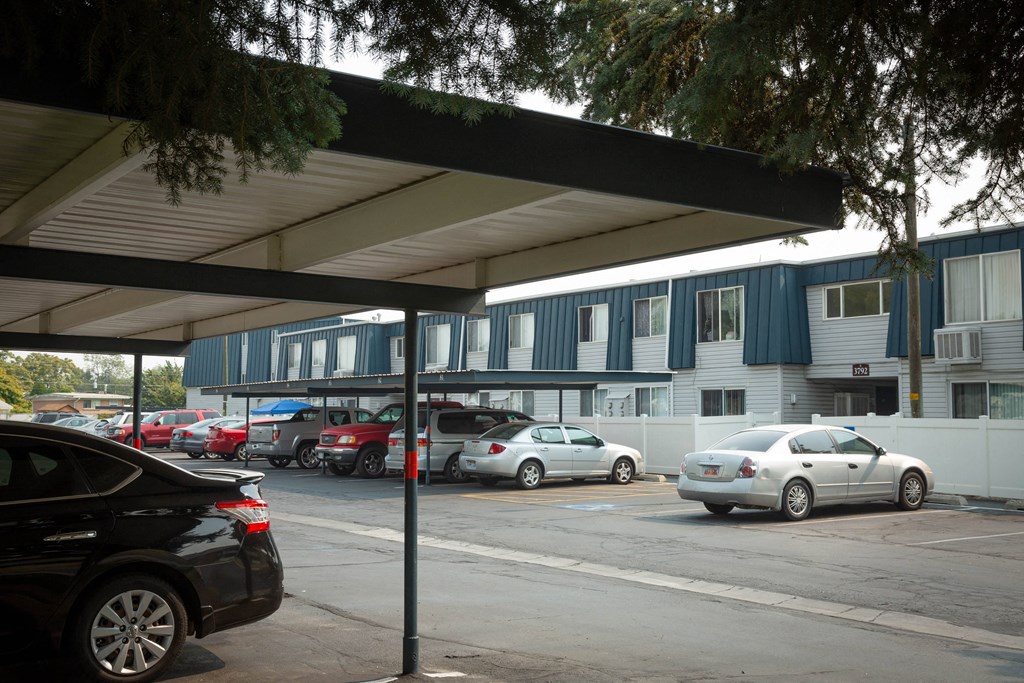 a parking lot with cars parked in front of a building