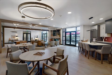 A modern dining room with a large table and chairs.