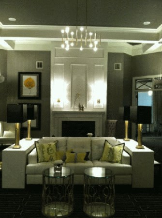 A living room with a white couch and a fireplace.