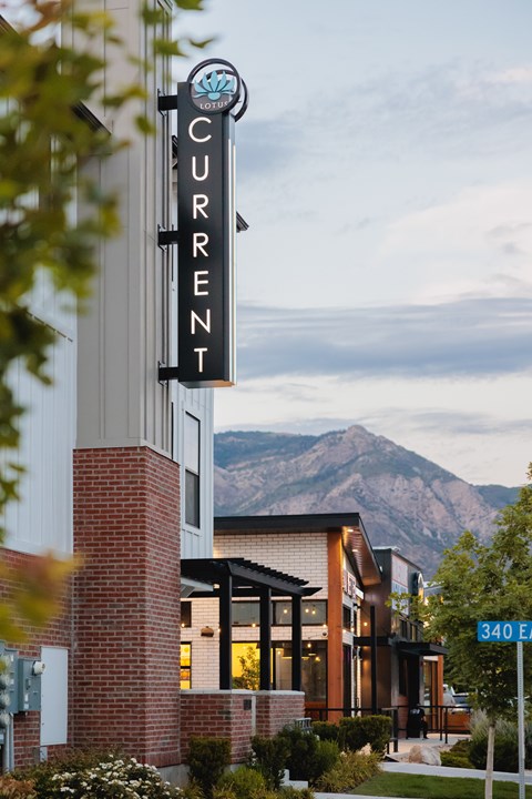 A building with a sign that says "CURRENT" on it.