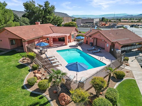 a birds eye view of a pool in front of a house