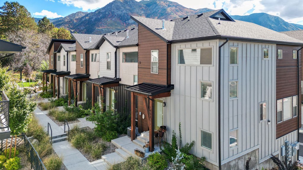 a row of houses with mountains in the background