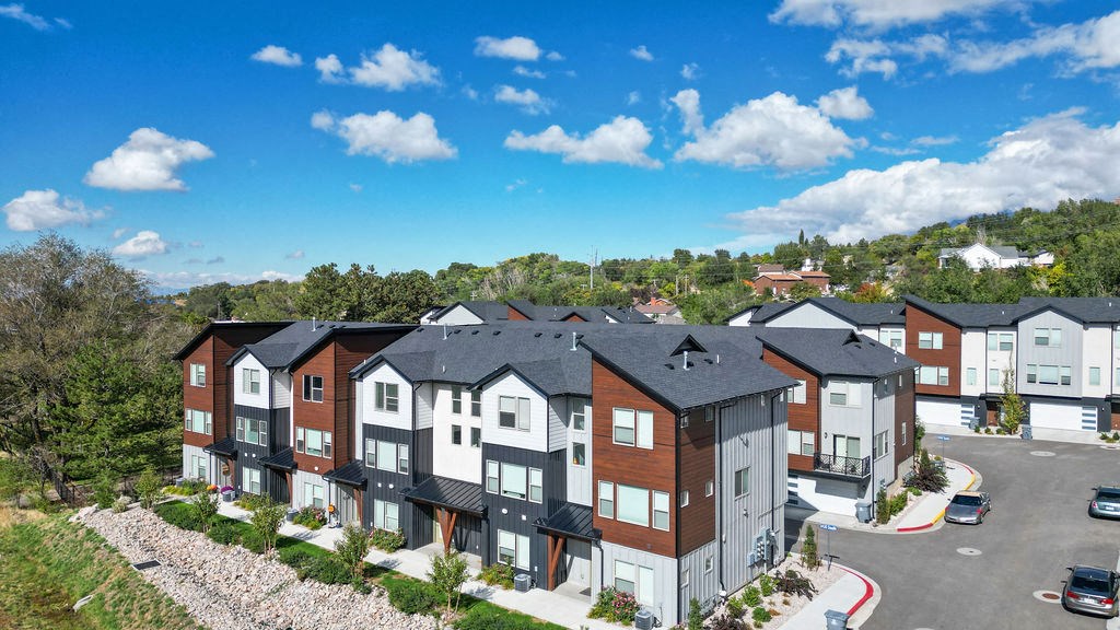an aerial view of an apartment building with a parking lot