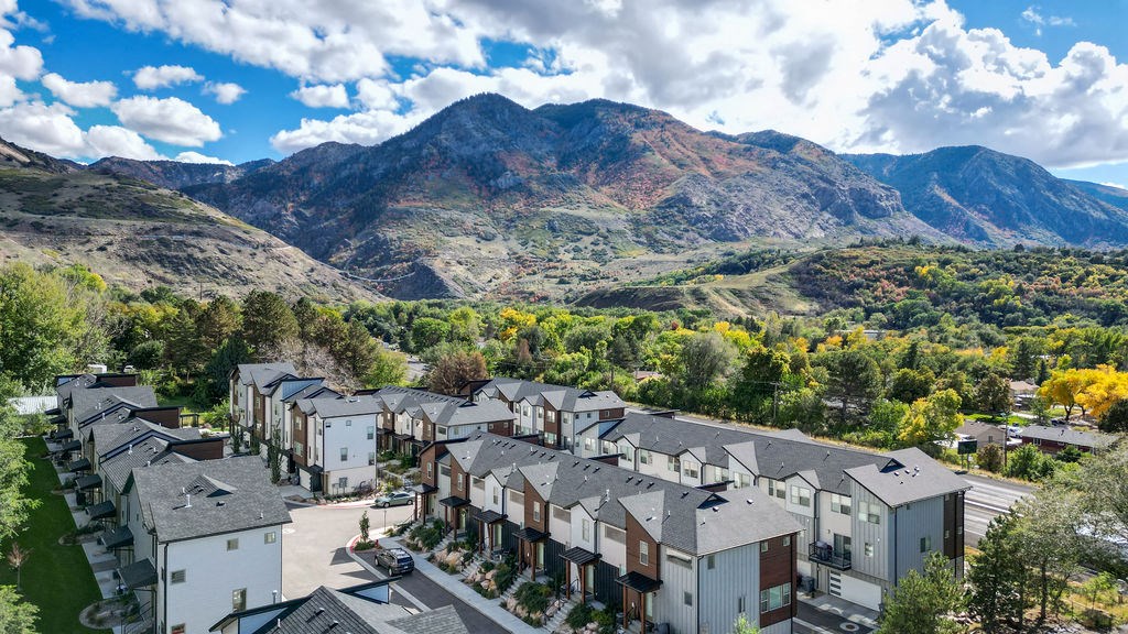 an aerial view of apartments with mountains in the background
