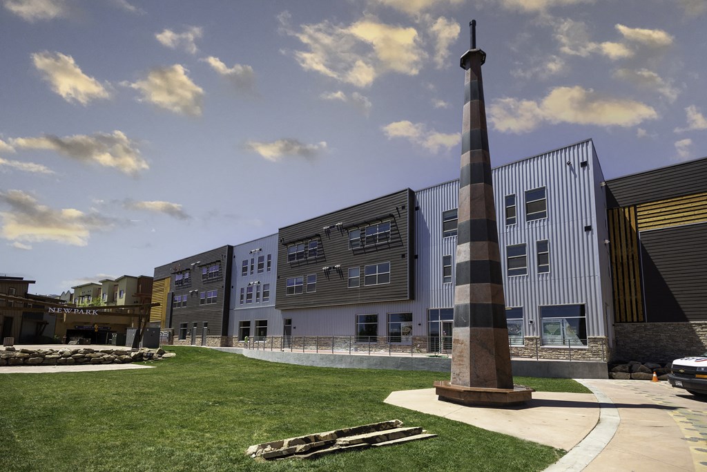 a tall pole in front of a building