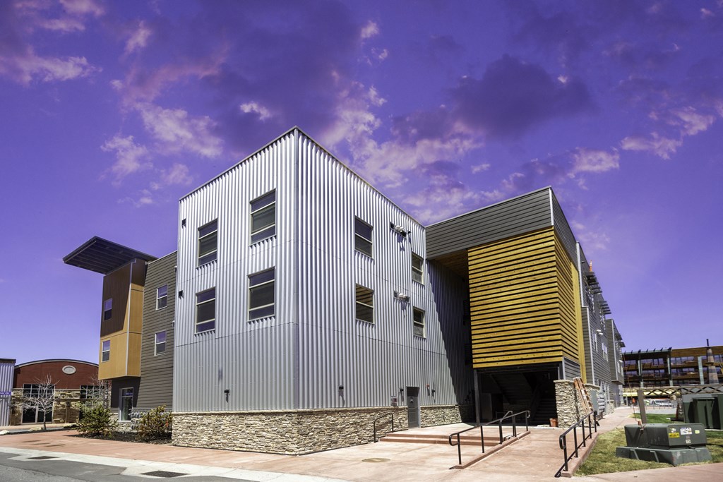 the exterior of a building with a metal facade and a staircase