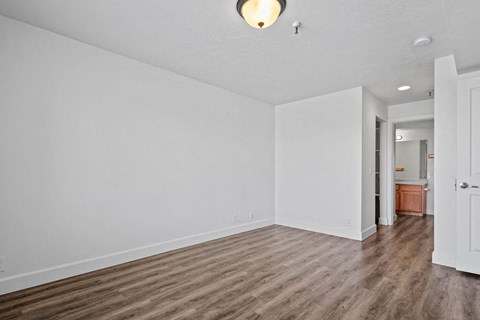A room with white walls and wooden flooring.