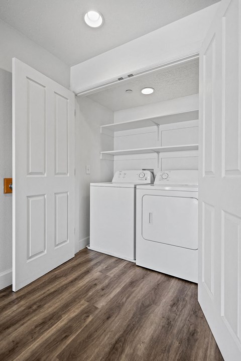 A white laundry room with a washer and dryer.