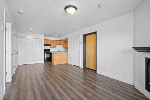 A kitchen with white cabinets and a wooden island.