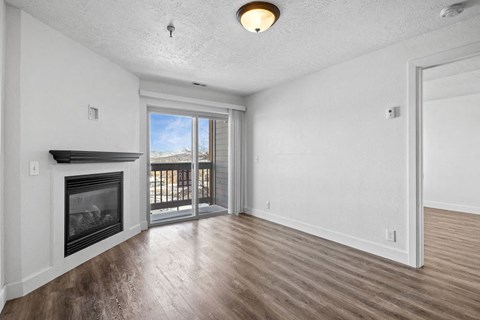 A room with a fireplace and sliding glass doors.