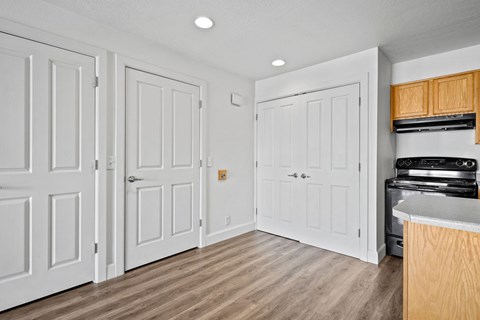A kitchen with white cabinets and a wooden island.