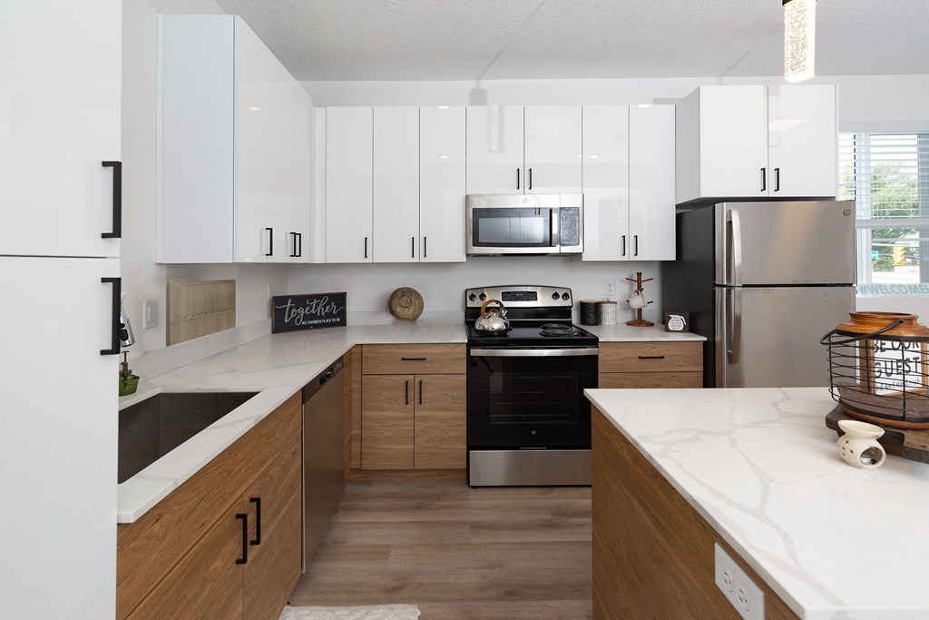 a kitchen with white cabinets and stainless steel appliances