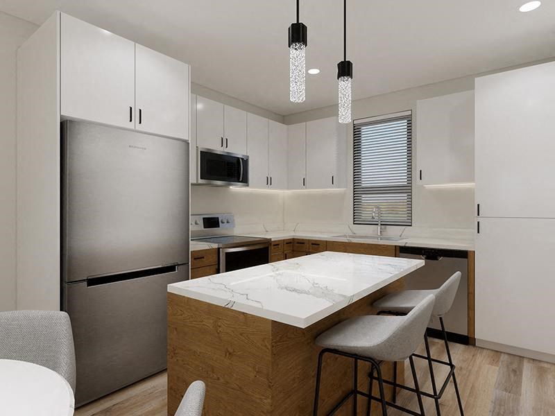 a kitchen with a large island with a marble counter top