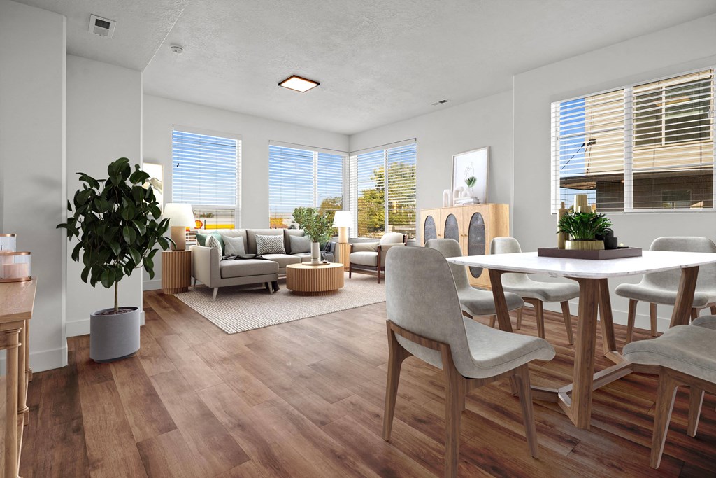 a living room and dining room with a table and chairs