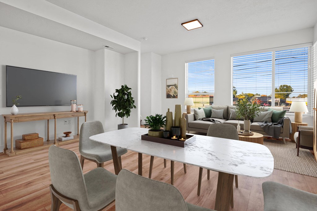 an open living room and dining room with a table and chairs