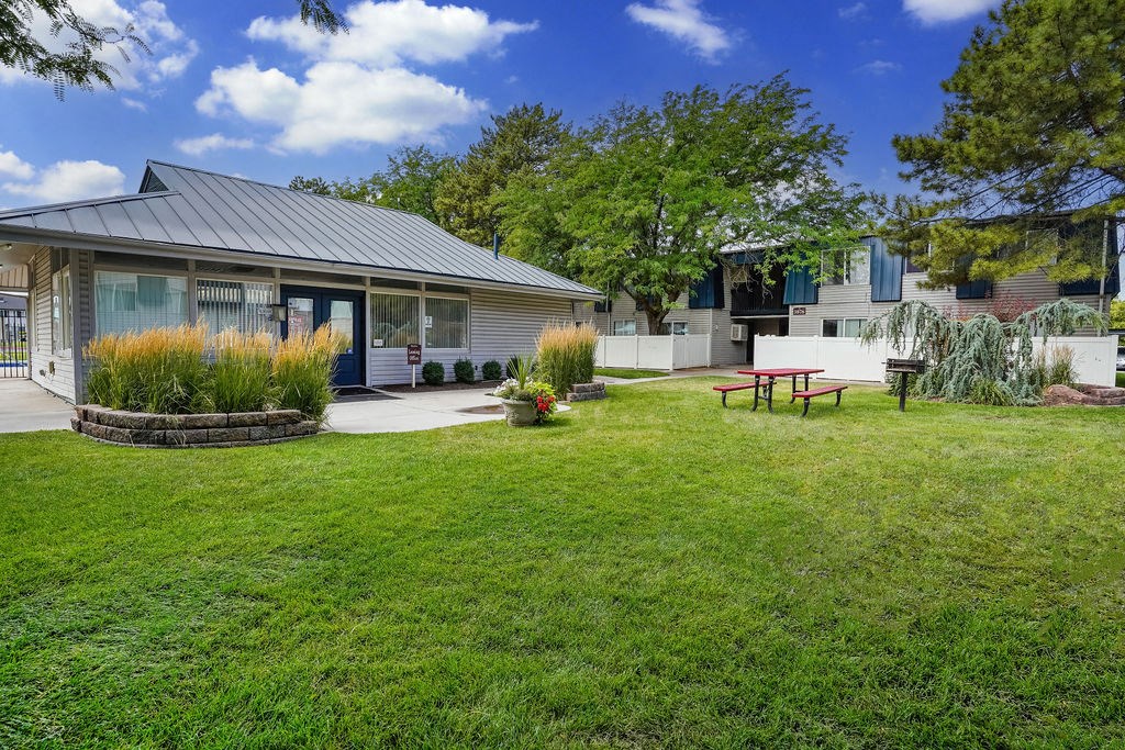 a backyard with a picnic table and a house