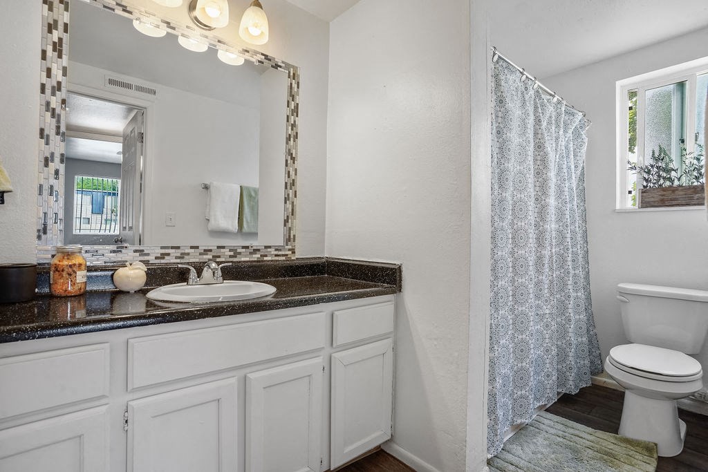 a bathroom with a sink toilet and a shower