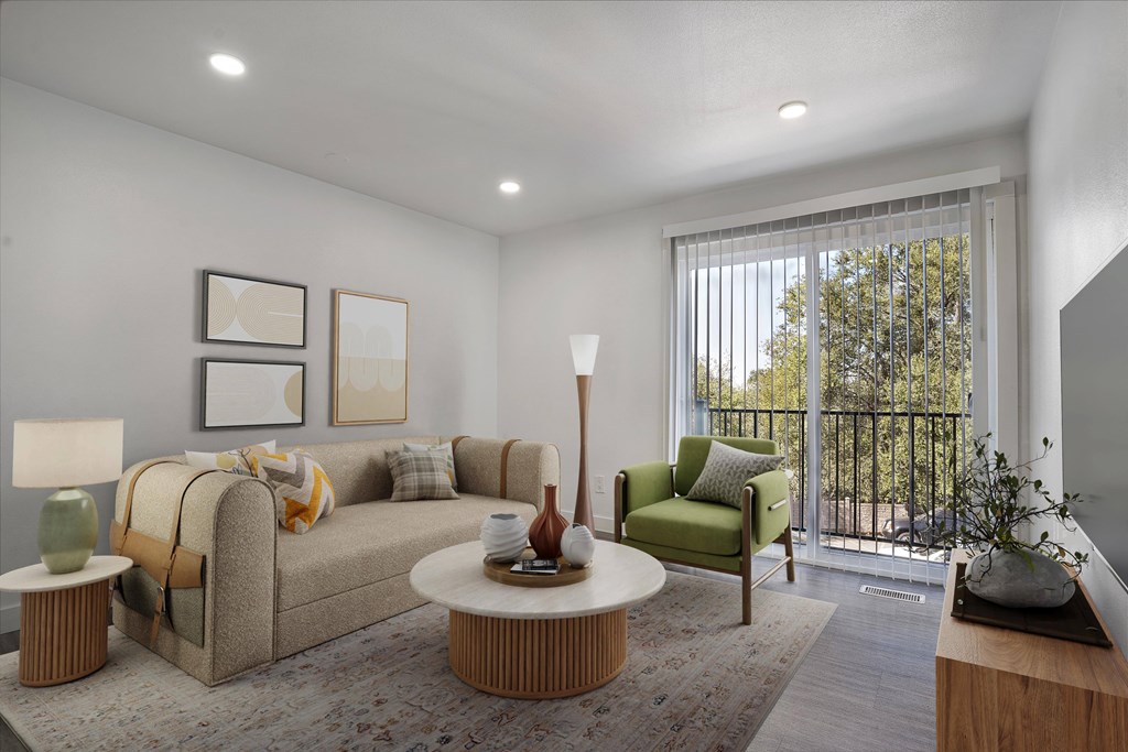 A living room with a couch, a chair, a table, and a lamp.