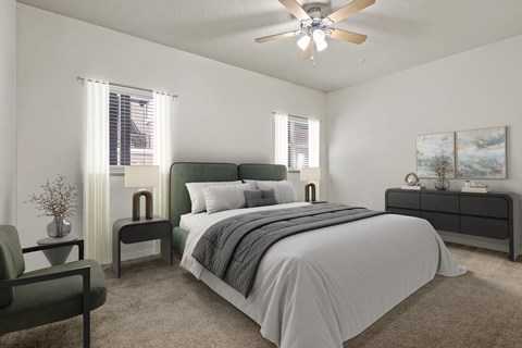 A bedroom with a large bed and a ceiling fan.
