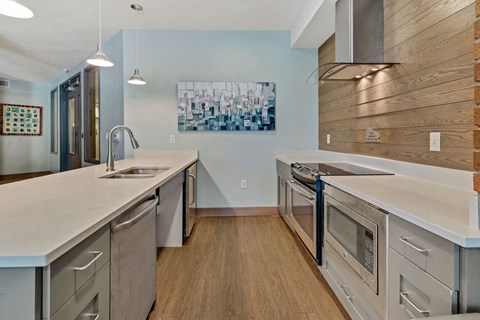 a kitchen with stainless steel appliances and white counter tops