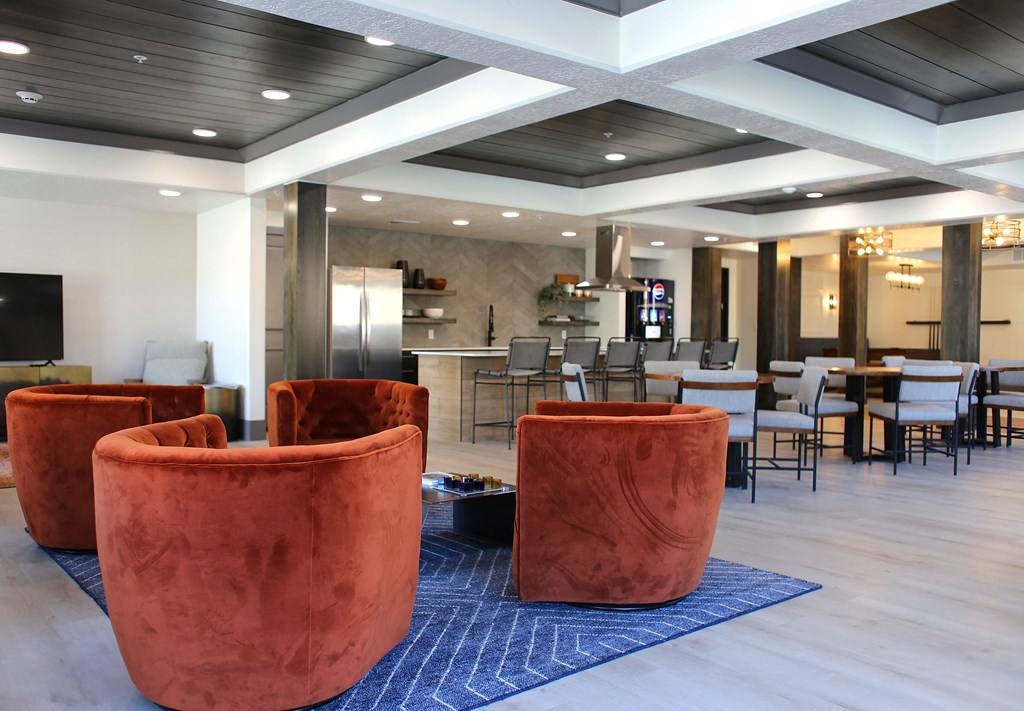 a lounge area with chairs and tables in a hotel lobby