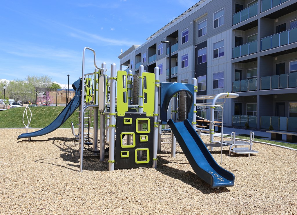 a playground at an apartment complex with slides