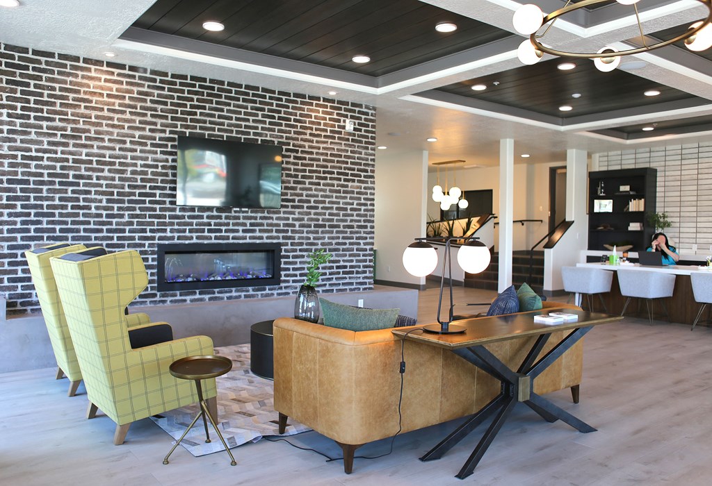 a living room with a fireplace and a table with chairs