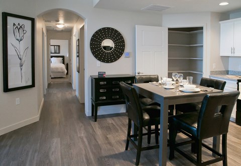 A dining room with a table set for two.