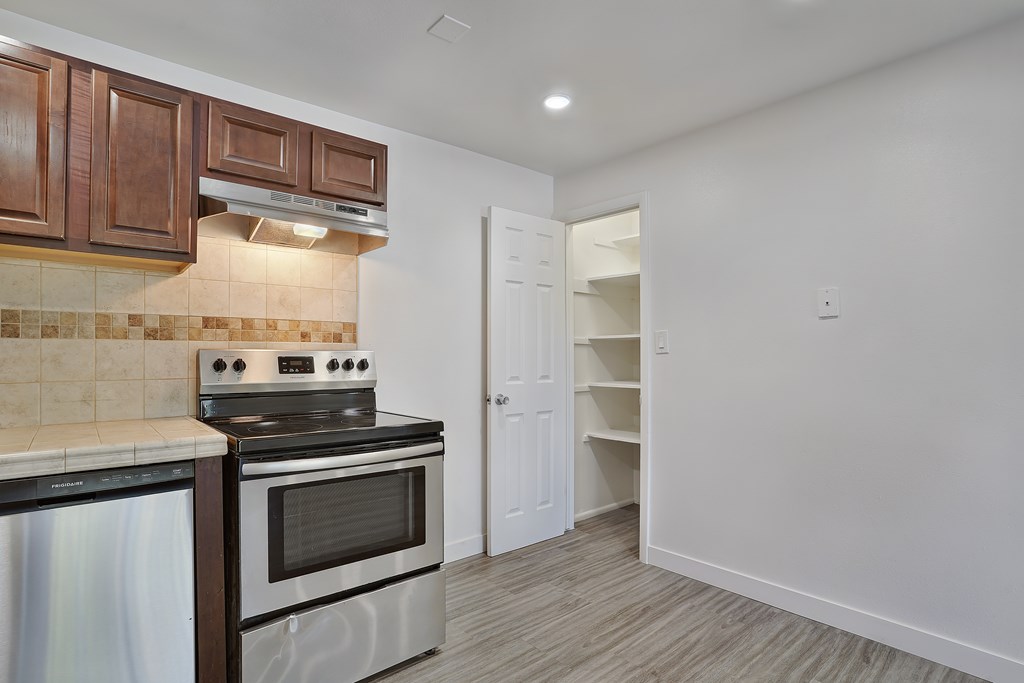 A kitchen with a stove top oven and a microwave.