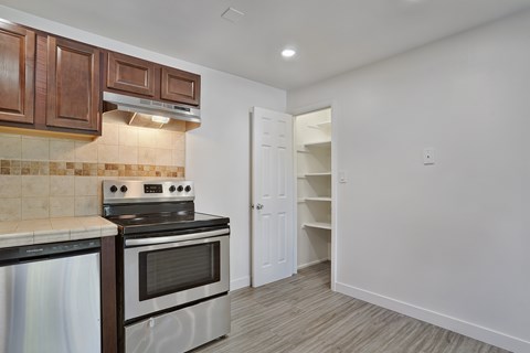 A kitchen with a stove top oven and a microwave.