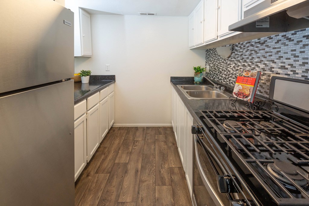 a kitchen with stainless steel appliances and a stove top oven