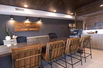 A row of chairs are lined up in front of a wooden sign that says Lotus.