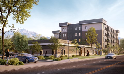 A modern building with a parking lot in front of it.