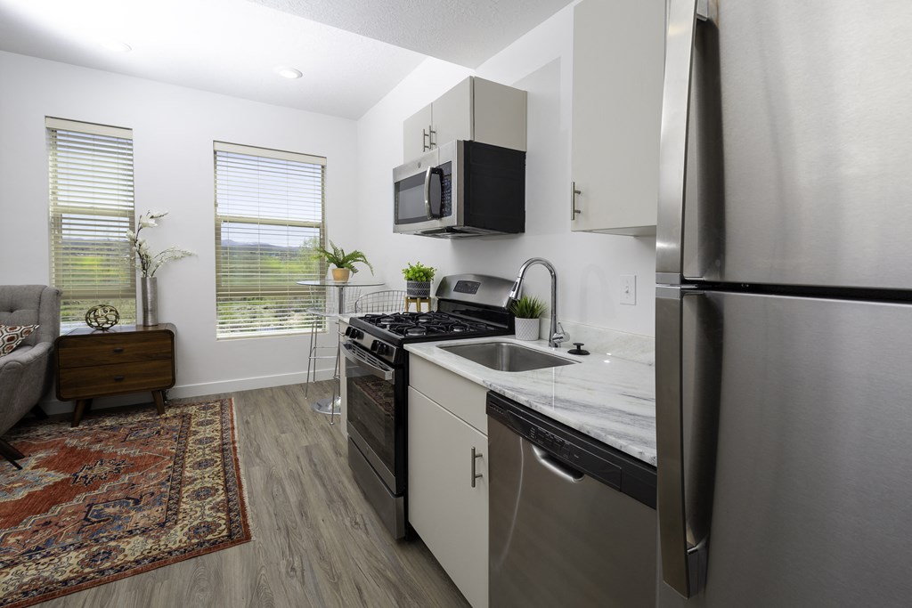 a kitchen with stainless steel appliances and a stainless steel refrigerator