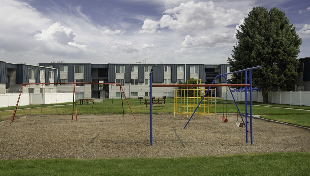 a playground in front of an apartment building