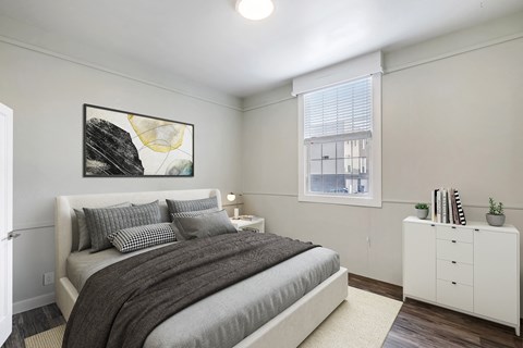 an apartment bedroom with a bed and a window