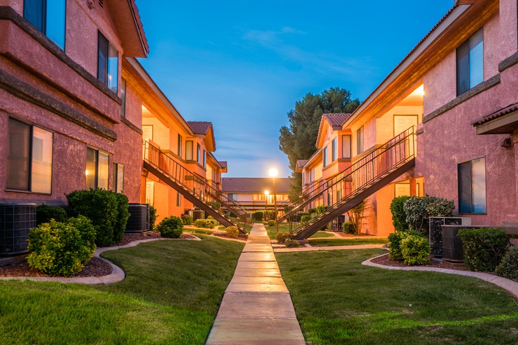 a walkway between buildings at night