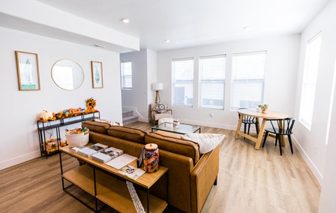 Open concept living and dining area with wood floors at Current by Lotus Apartments, Utah