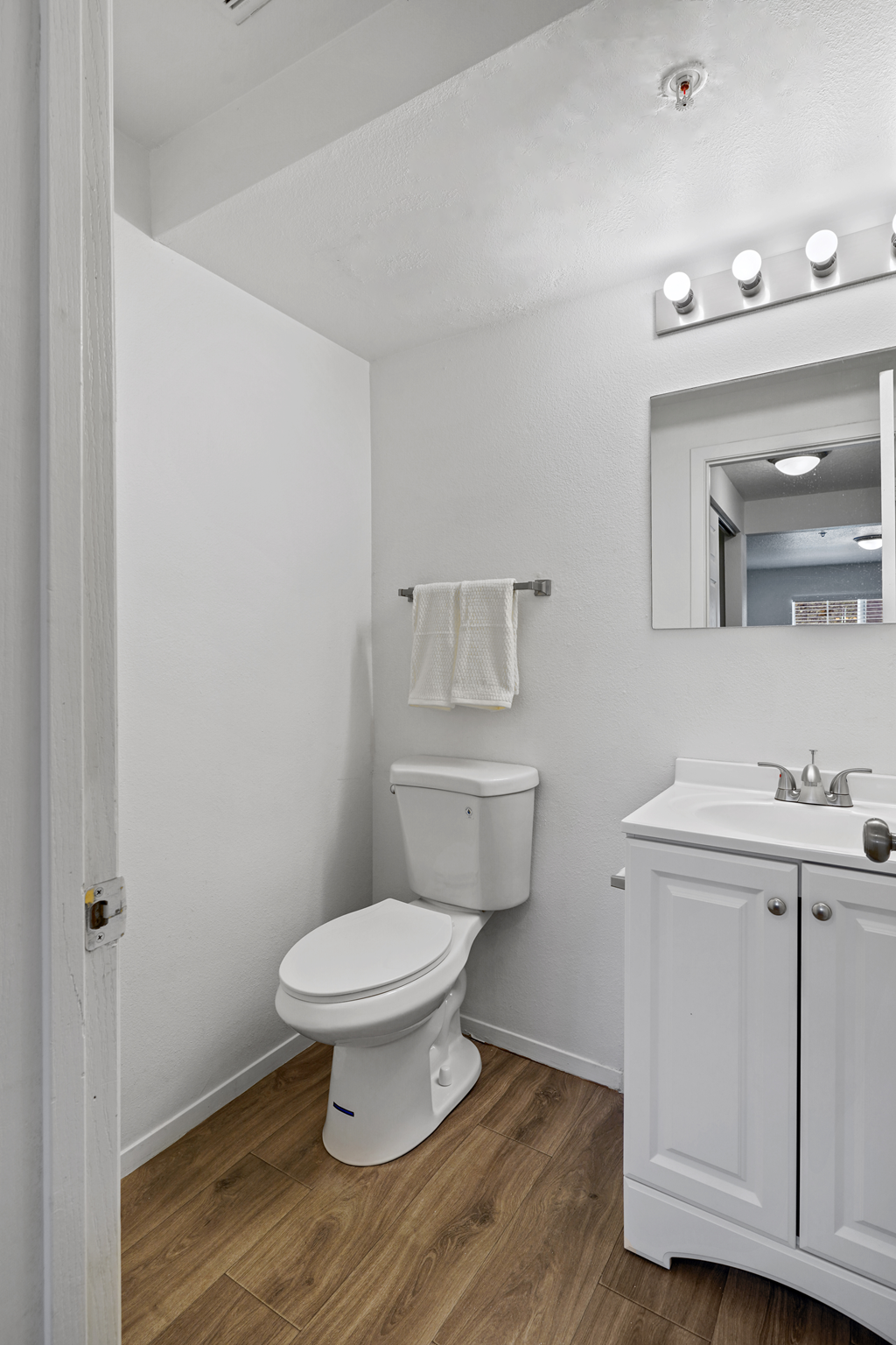 a white bathroom with a toilet and a sink