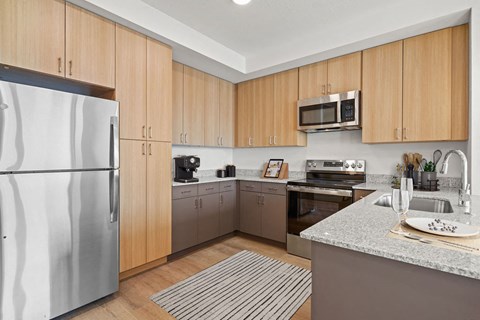 a kitchen with stainless steel appliances and wooden cabinets