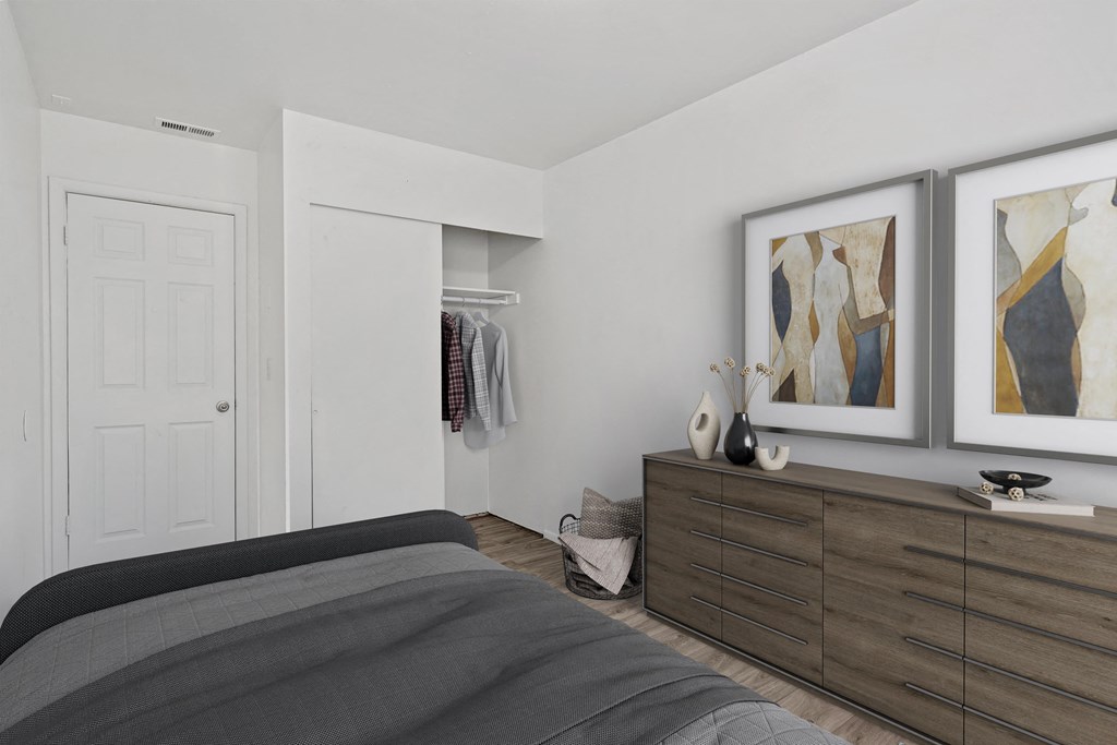 a bedroom with a large bed and two paintings on the wall