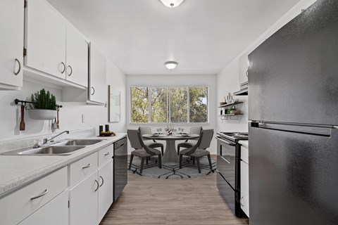 A modern kitchen with a large island and a refrigerator.
