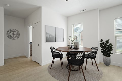 A dining room with a table and chairs.