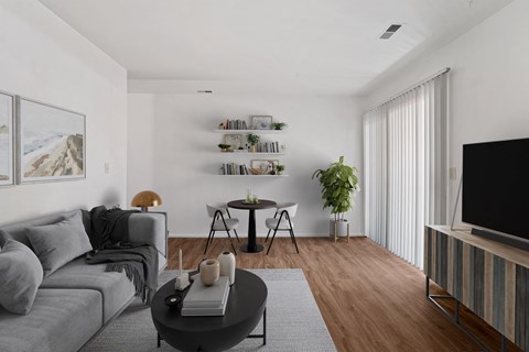 a living room with a gray couch and a table and a television