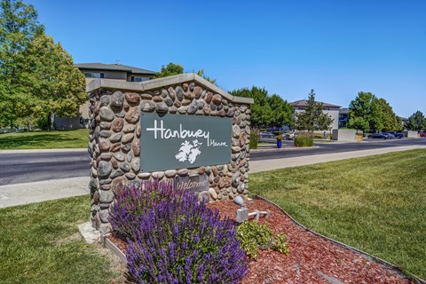 A stone sign that says Hanbury in front of a building.