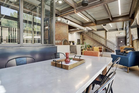 A dining room with a long table and chairs.