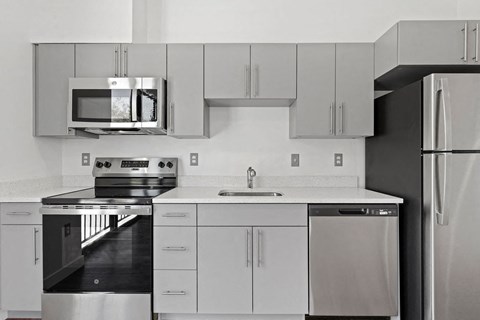 a kitchen with stainless steel appliances and white cabinets