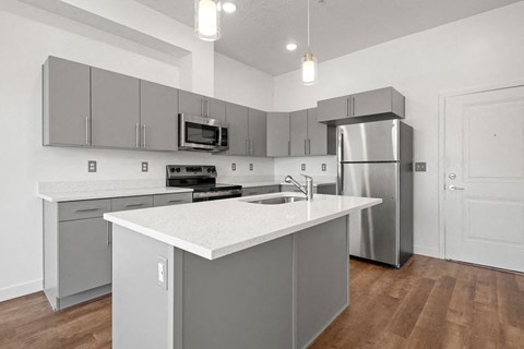 a kitchen with stainless steel appliances and a white counter top